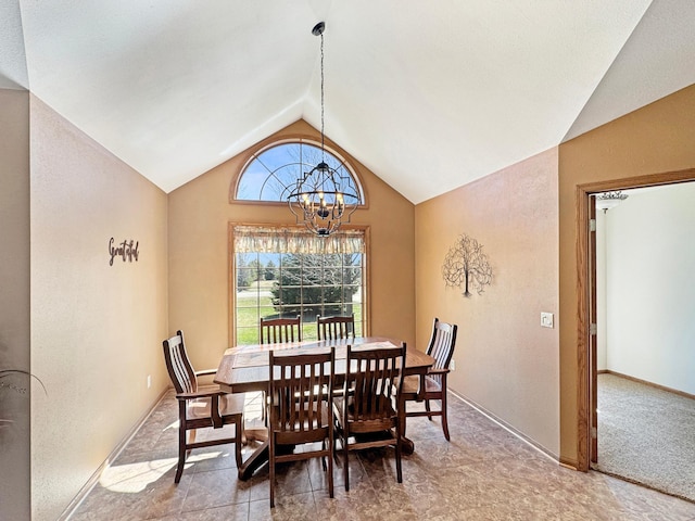 dining room featuring a chandelier and lofted ceiling