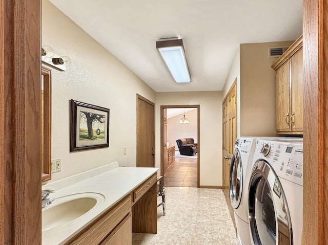 laundry area with a sink, separate washer and dryer, light tile patterned flooring, cabinet space, and visible vents