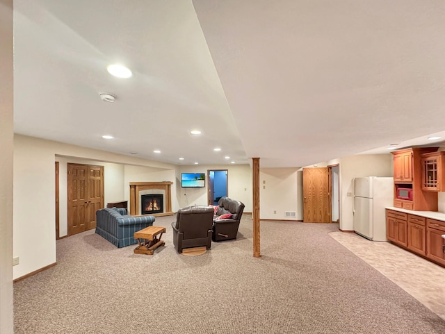 living area featuring light carpet, visible vents, recessed lighting, and a lit fireplace