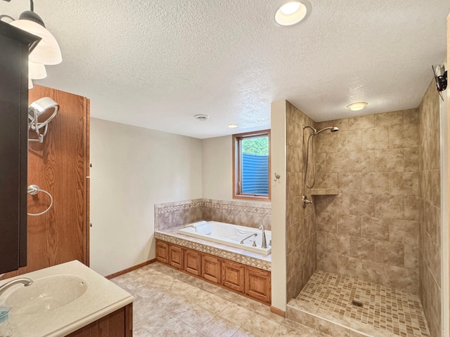 full bathroom with a tile shower, tile patterned floors, a bath, baseboards, and a textured ceiling
