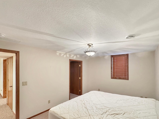 bedroom featuring carpet floors and a textured ceiling