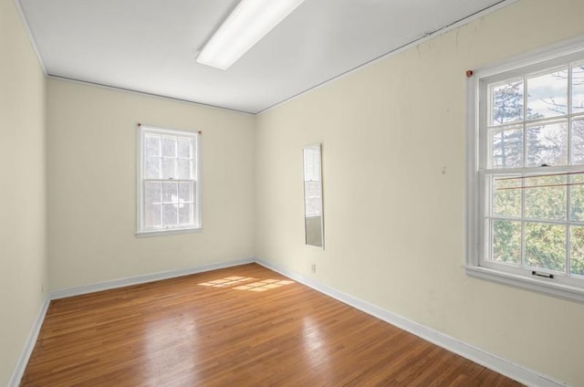 unfurnished room featuring wood finished floors and baseboards