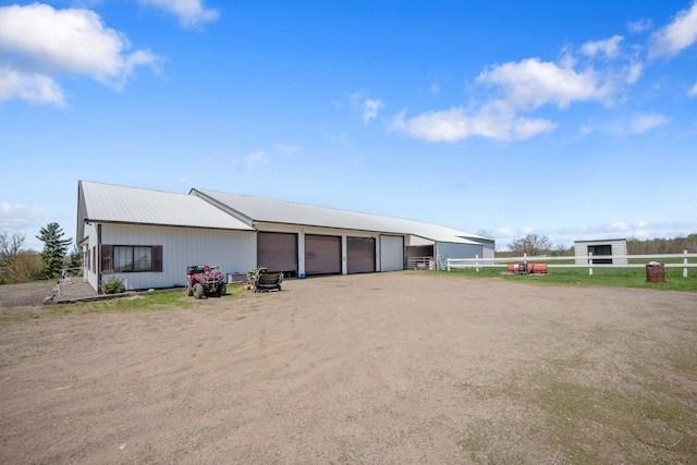 12446 190th St, Page Twp, MN 56353 - garage with fence, a garage, and dirt driveway