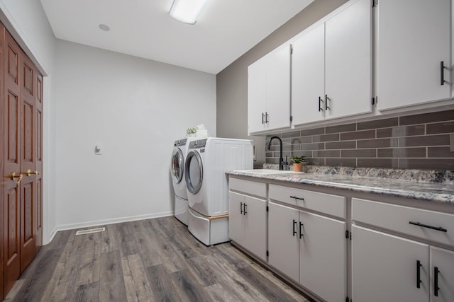 12446 190th St, Page Twp, MN 56353 - laundry area with cabinet space, washing machine and dryer, and wood finished floors