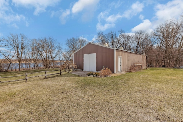 view of pole building with a yard and fence