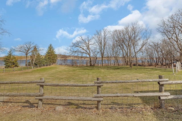 view of yard with a rural view and fence