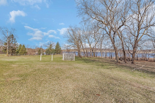 view of yard featuring fence and a water view