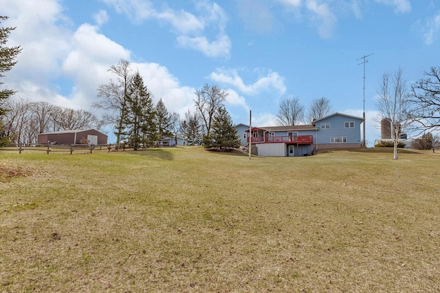 view of yard featuring fence and a deck