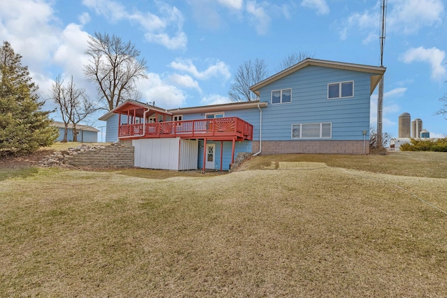 back of property featuring a lawn and a wooden deck