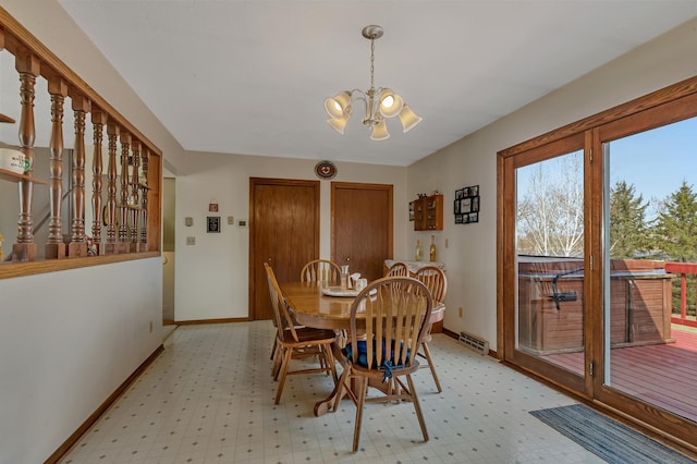 dining area featuring a wealth of natural light, baseboards, and a notable chandelier