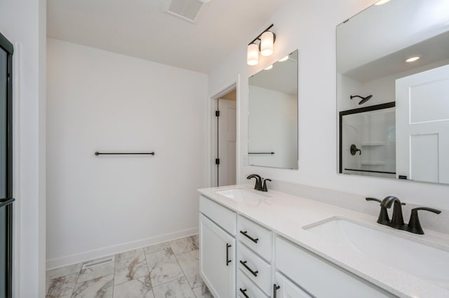 bathroom with marble finish floor, walk in shower, a sink, and visible vents