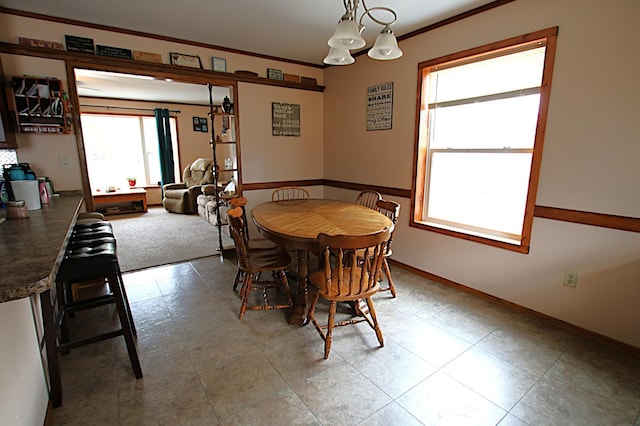 dining area with baseboards and ornamental molding