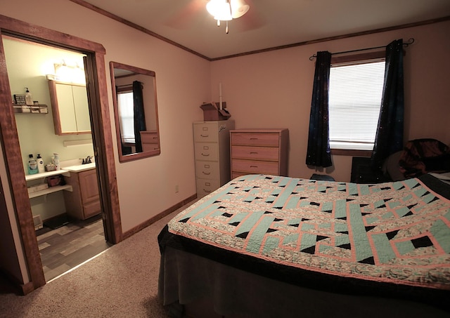 bedroom with ensuite bathroom, baseboards, light colored carpet, ceiling fan, and crown molding