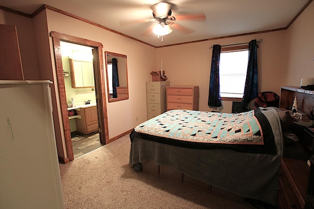bedroom featuring a sink, ensuite bath, crown molding, light colored carpet, and ceiling fan