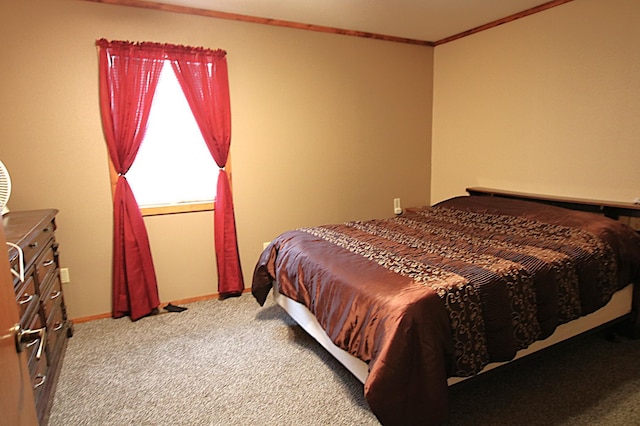 carpeted bedroom with baseboards and ornamental molding