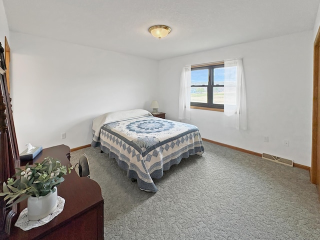 carpeted bedroom featuring baseboards and visible vents