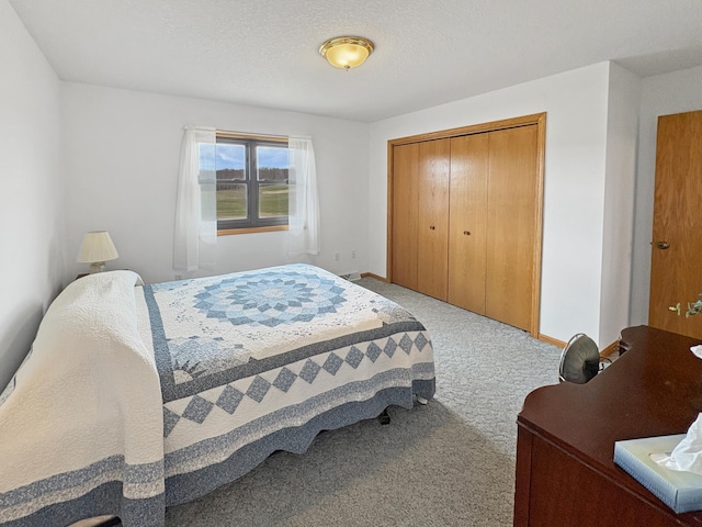 bedroom with baseboards, carpet floors, and a closet