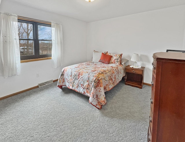bedroom featuring baseboards, carpet flooring, and visible vents