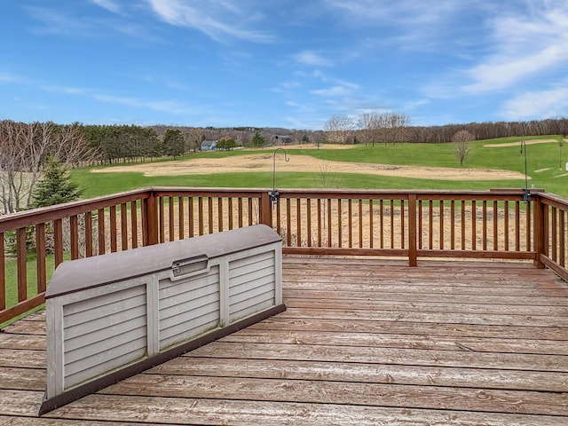 deck featuring a yard and view of golf course