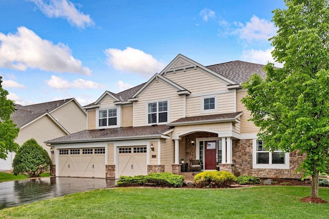 view of front of house with stone siding, a garage, asphalt driveway, a front lawn, and roof with shingles