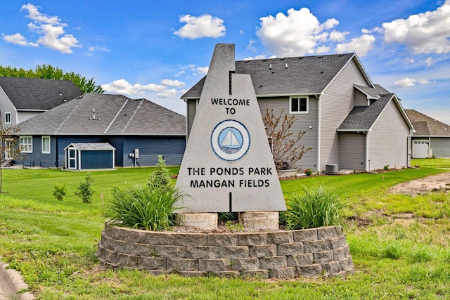 community / neighborhood sign with a yard