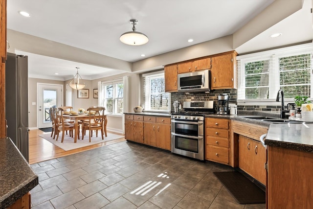 312 Walnut St, Taylors Falls, MN 55084 - kitchen with appliances with stainless steel finishes, a sink, dark countertops, plenty of natural light, and recessed lighting