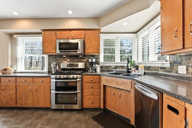 312 Walnut St, Taylors Falls, MN 55084 - kitchen featuring stainless steel appliances, a sink, healthy amount of natural light, dark countertops, and recessed lighting
