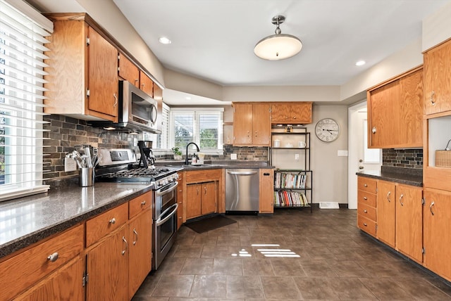 312 Walnut St, Taylors Falls, MN 55084 - kitchen featuring appliances with stainless steel finishes, backsplash, a sink, brown cabinets, and recessed lighting