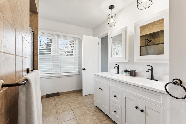 312 Walnut St, Taylors Falls, MN 55084 - bathroom with a tile shower, double vanity, tile patterned floors, and baseboards