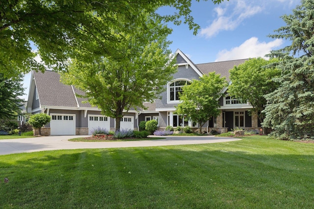 9726 Whistling Valley Rd, Lake Elmo, MN 55042 - view of front of house with concrete driveway, a front yard, stone siding, an attached garage, and a shingled roof