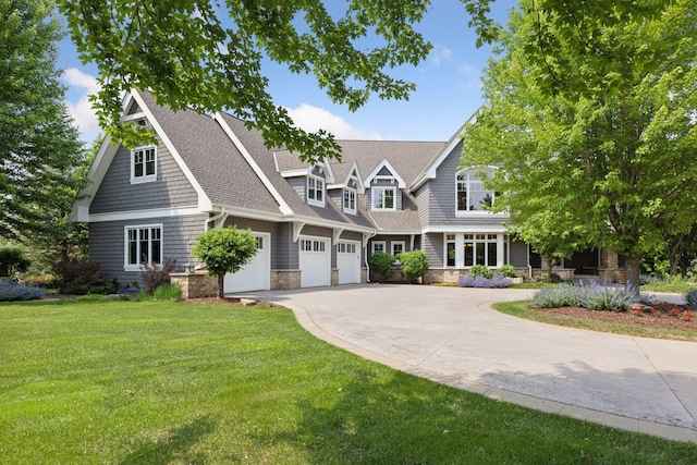 9726 Whistling Valley Rd, Lake Elmo, MN 55042 - shingle-style home featuring driveway, stone siding, a front yard, a garage, and a shingled roof