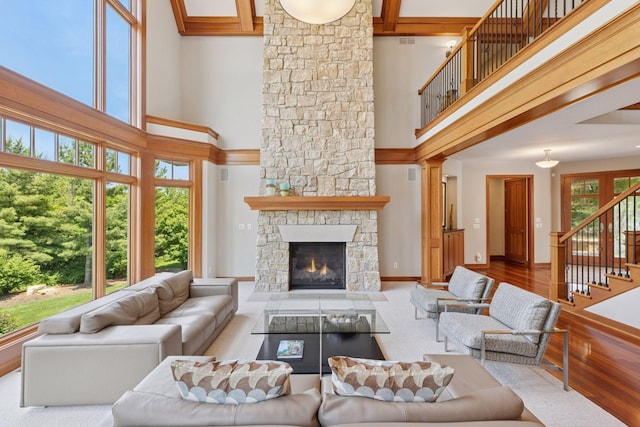 9726 Whistling Valley Rd, Lake Elmo, MN 55042 - living area featuring a high ceiling, stairway, wood finished floors, a fireplace, and baseboards