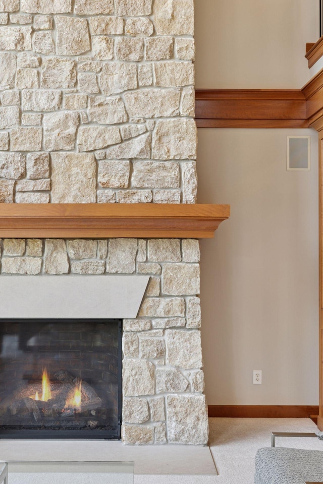 9726 Whistling Valley Rd, Lake Elmo, MN 55042 - detailed view of carpet flooring, a lit fireplace, and baseboards