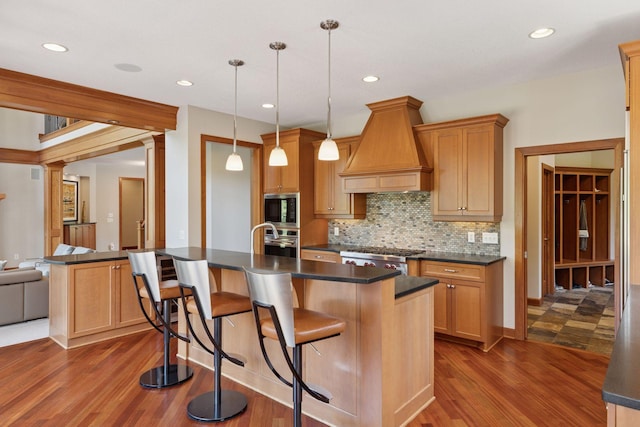 9726 Whistling Valley Rd, Lake Elmo, MN 55042 - kitchen with appliances with stainless steel finishes, custom exhaust hood, dark countertops, and recessed lighting