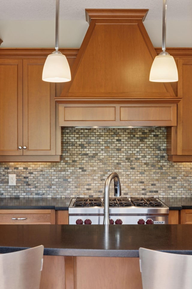 9726 Whistling Valley Rd, Lake Elmo, MN 55042 - kitchen featuring dark countertops, backsplash, hanging light fixtures, brown cabinetry, and a textured ceiling