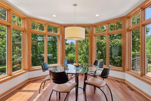 9726 Whistling Valley Rd, Lake Elmo, MN 55042 - sunroom / solarium with baseboards, wood finished floors, plenty of natural light, and recessed lighting