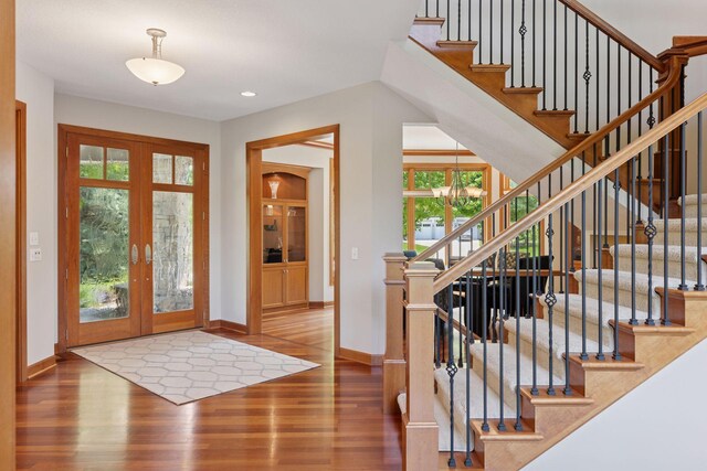 9726 Whistling Valley Rd, Lake Elmo, MN 55042 - foyer entrance with french doors, wood finished floors, baseboards, stairs, and recessed lighting