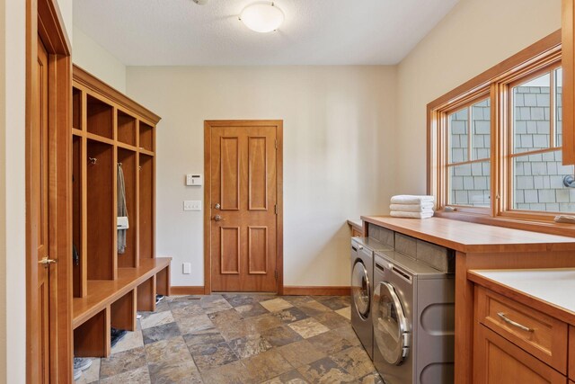 9726 Whistling Valley Rd, Lake Elmo, MN 55042 - laundry area with independent washer and dryer, baseboards, and dark stone finish flooring