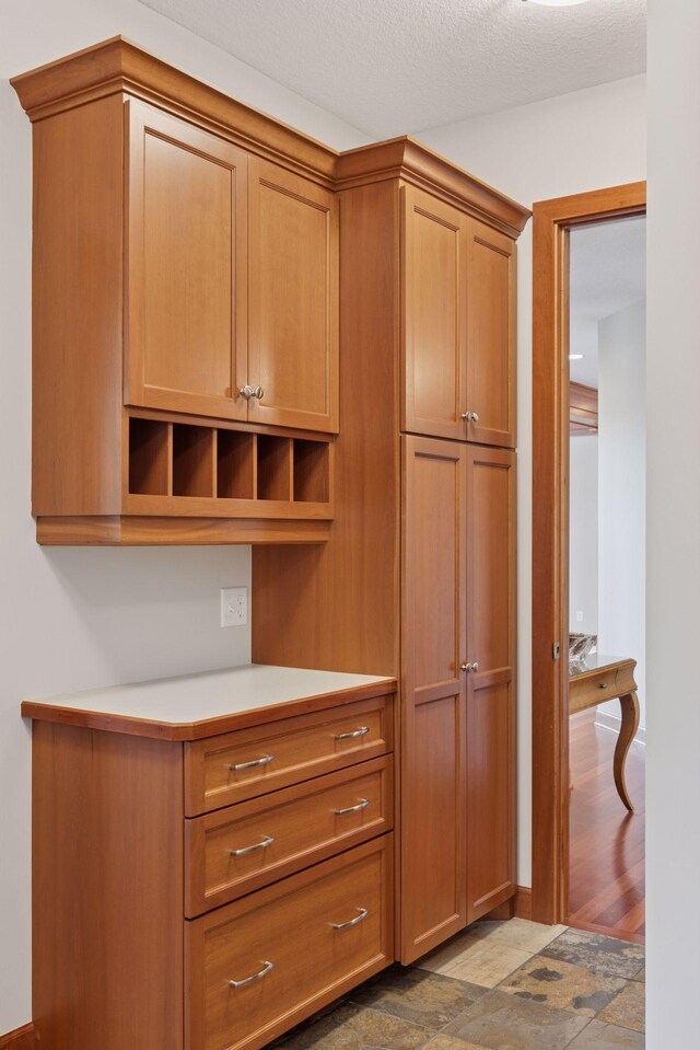 9726 Whistling Valley Rd, Lake Elmo, MN 55042 - kitchen featuring open shelves, light countertops, and brown cabinetry