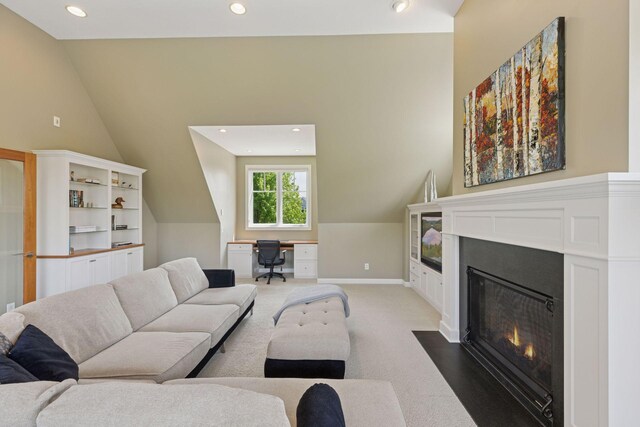 9726 Whistling Valley Rd, Lake Elmo, MN 55042 - living area featuring vaulted ceiling, recessed lighting, light colored carpet, a fireplace with flush hearth, and an office area