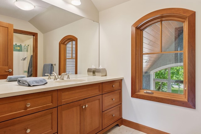 9726 Whistling Valley Rd, Lake Elmo, MN 55042 - full bath featuring lofted ceiling, vanity, and baseboards