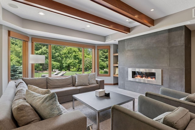 9726 Whistling Valley Rd, Lake Elmo, MN 55042 - living area with a tiled fireplace, beamed ceiling, and recessed lighting