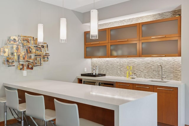 9726 Whistling Valley Rd, Lake Elmo, MN 55042 - indoor wet bar featuring decorative backsplash and hanging light fixtures