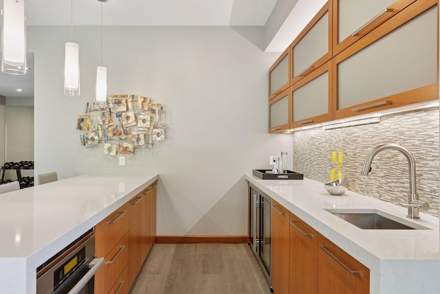 9726 Whistling Valley Rd, Lake Elmo, MN 55042 - indoor wet bar featuring backsplash, hanging light fixtures, beverage cooler, baseboards, and stainless steel oven