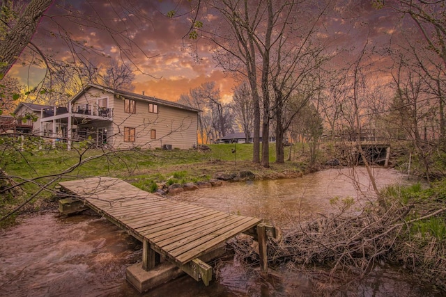 view of home's community featuring a boat dock and a water view
