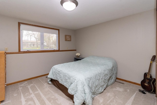 bedroom featuring baseboards and carpet flooring
