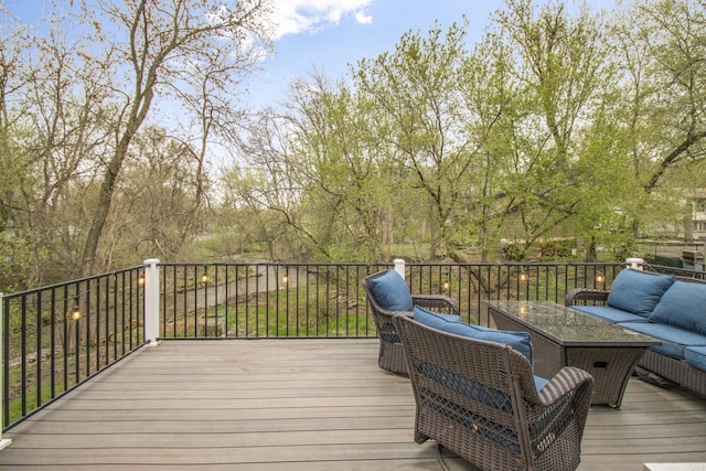wooden terrace with an outdoor living space