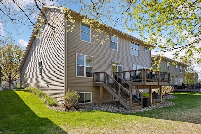 back of property featuring a wooden deck, a yard, and stairs