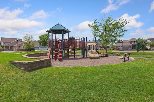 community jungle gym featuring a yard and a residential view