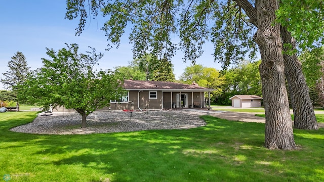 2368 State Highway 9 N, Spring Prairie Twp, MN 56547 - rear view of house featuring a yard, an outdoor structure, a detached garage, and a porch